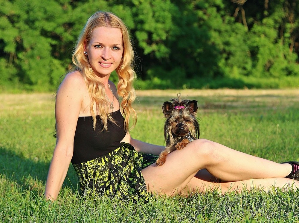 A pet owner and their dog reunited, showing joy and relief after a boarding stay