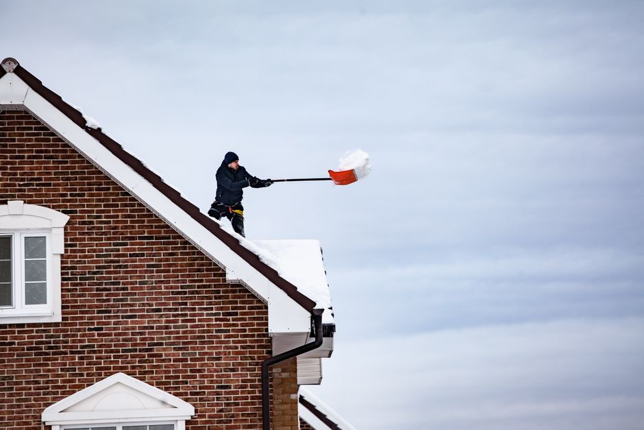 Professional seasonal roof maintenance service showing clean gutters and roof inspection